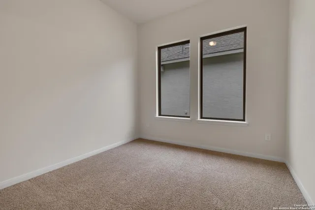 an empty room with windows and closet