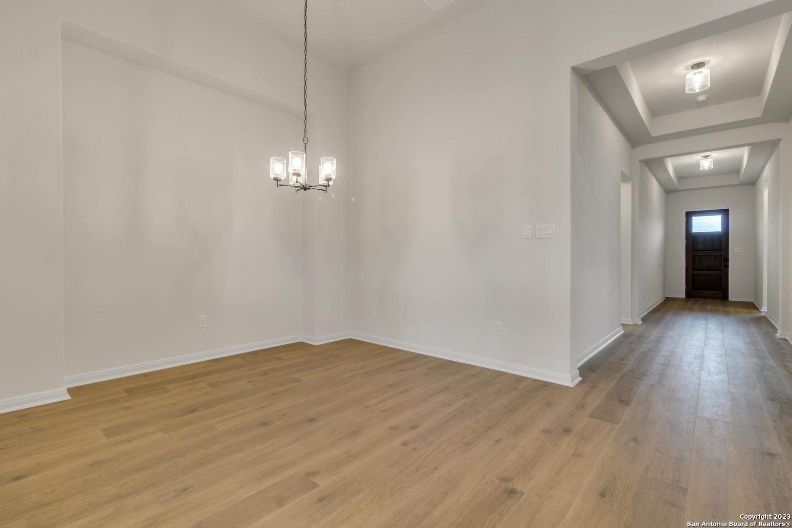 104 Matador Boerne, TX 78006 - Photo 3 of 33 a view of a room with wooden floor and a chandelier