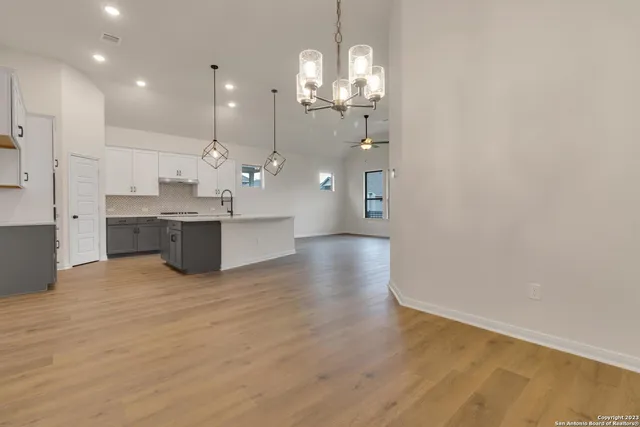 a view of a kitchen with kitchen island a sink stainless steel appliances and cabinets
