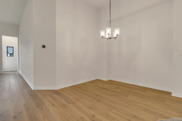 a view of a chandelier in big room and chandelier fan