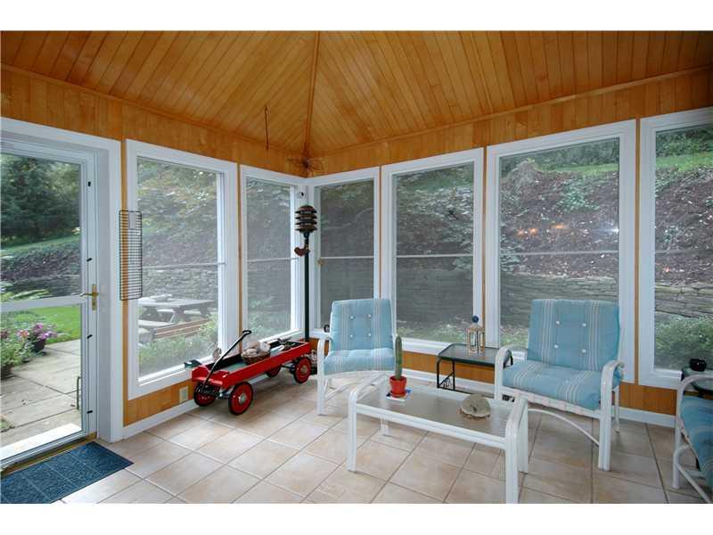 20 Thornridge Road Pittsburgh, PA 15237 - Photo 6 of 24 Other. Windowed sunroom adjacent to outdoor patio area.