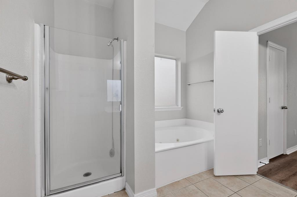 3401 Newgate Street Midlothian, TX 76065 - Photo 25 of 34 Bathroom featuring a glass-enclosed shower, corner soaking tub, small frosted window, and tile flooring