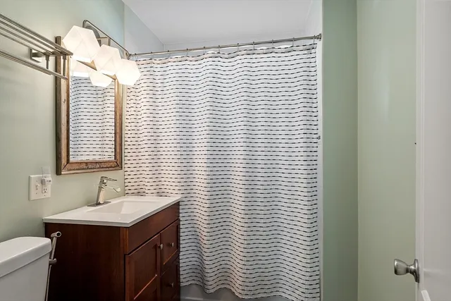 a bathroom with a sink a vanity and a toilet