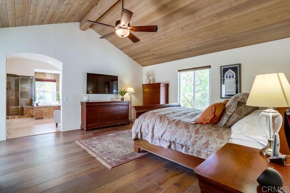 1283 Rancho Encinitas Drive Encinitas, CA 92024 - Photo 13 of 27 a bedroom with a bed a couch and dresser