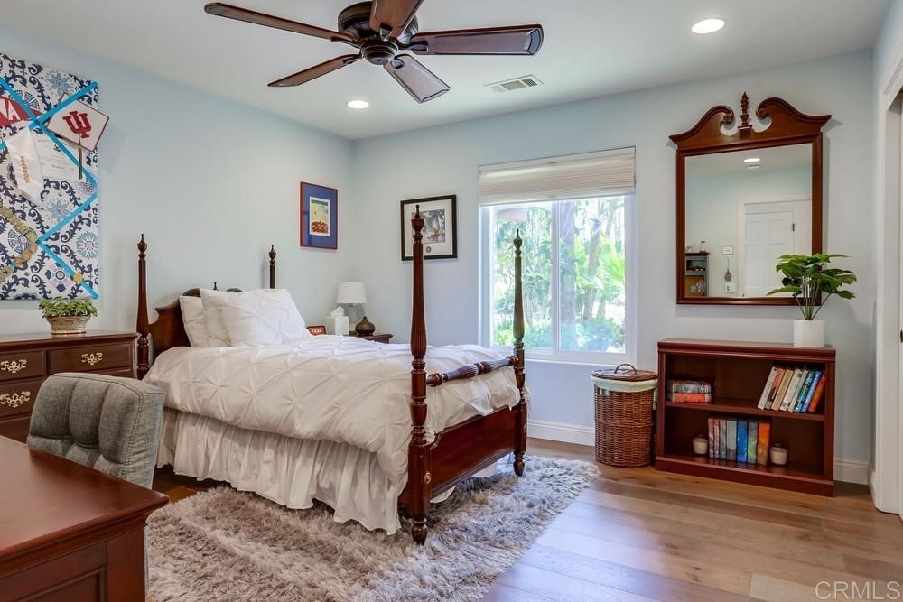 1283 Rancho Encinitas Drive Encinitas, CA 92024 - Photo 15 of 27 a bed room with a bed and a book shelf