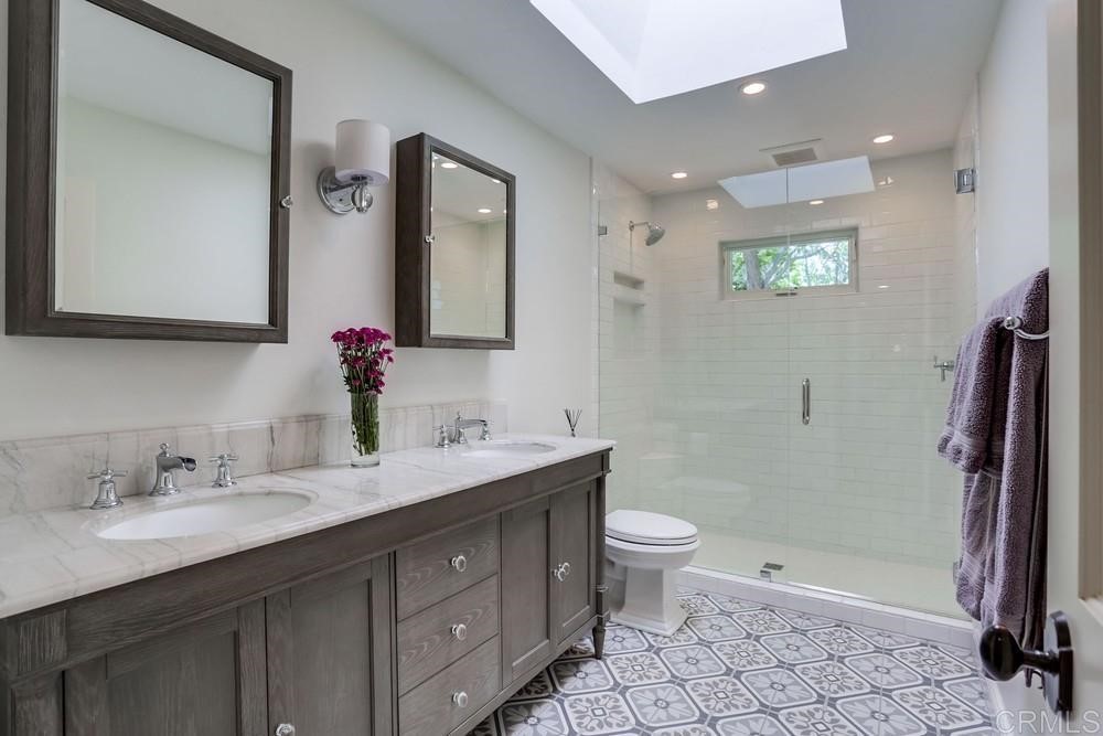 1283 Rancho Encinitas Drive Encinitas, CA 92024 - Photo 16 of 27 a bathroom with a double vanity sink mirror and toilet