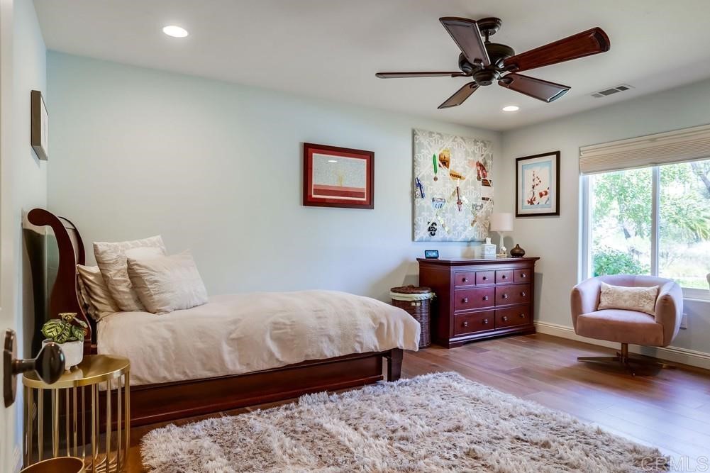 1283 Rancho Encinitas Drive Encinitas, CA 92024 - Photo 17 of 27 a bedroom with a bed dresser and a window