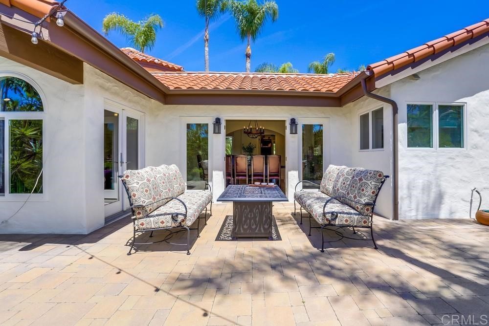 1283 Rancho Encinitas Drive Encinitas, CA 92024 - Photo 19 of 27 a view of a dinning tables and chairs in patio