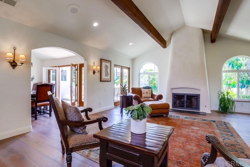 1283 Rancho Encinitas Drive Encinitas, CA 92024 - Photo 7 of 27 a living room with furniture a fireplace and a potted plant