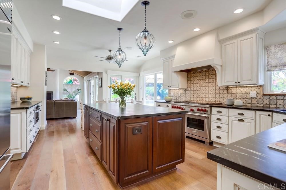 1283 Rancho Encinitas Drive Encinitas, CA 92024 - Photo 9 of 27 a kitchen with stainless steel appliances granite countertop a sink a stove top oven a counter space and cabinets
