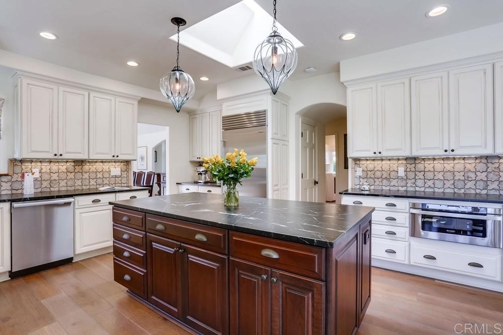 1283 Rancho Encinitas Drive Encinitas, CA 92024 - Photo 10 of 27 a kitchen with granite countertop a sink cabinets and stainless steel appliances