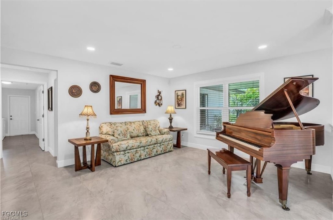 3644 Putter Point Lane Fort Myers, FL 33919 - Photo 14 of 50 a living room with furniture and a window