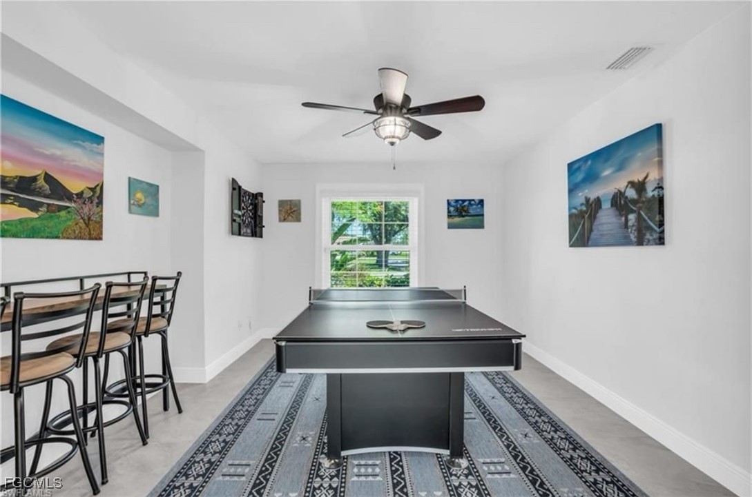 3644 Putter Point Lane Fort Myers, FL 33919 - Photo 18 of 50 a workspace with wooden floor and a potted plant