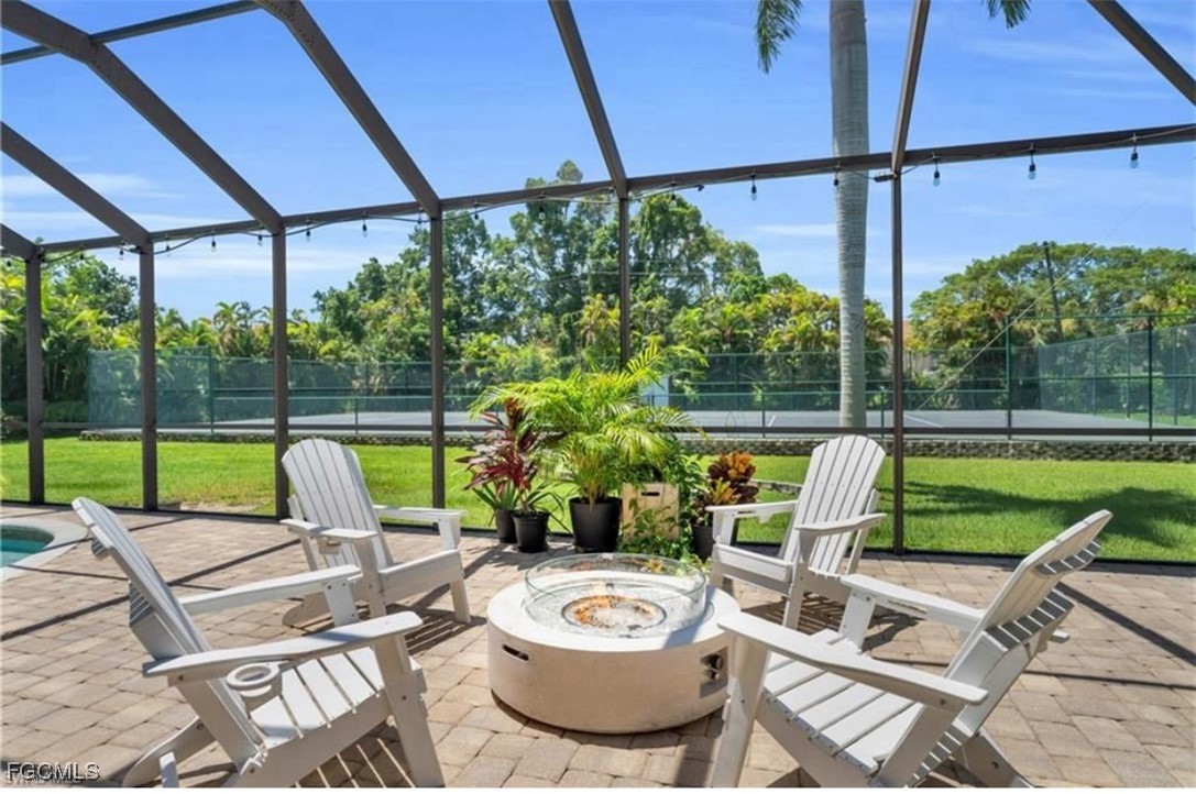 3644 Putter Point Lane Fort Myers, FL 33919 - Photo 36 of 50 a view of a patio with a table chairs and a swimming pool