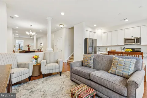 a living room with furniture and kitchen view