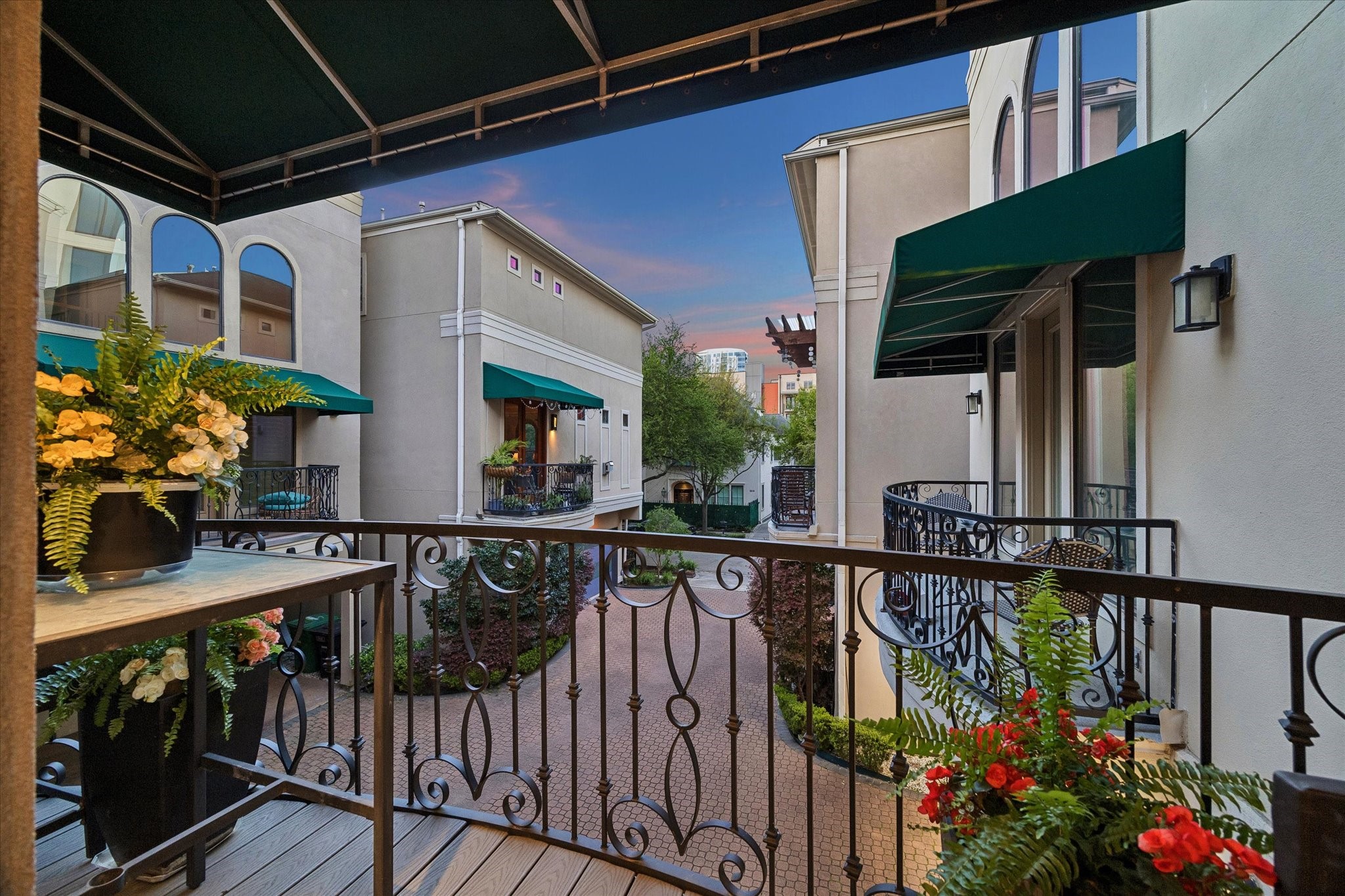 2415 W Main Street... Outdoor living is equally refined. Two balconies—each with custom awnings—provide serene retreats for morning coffee or evening unwinding.