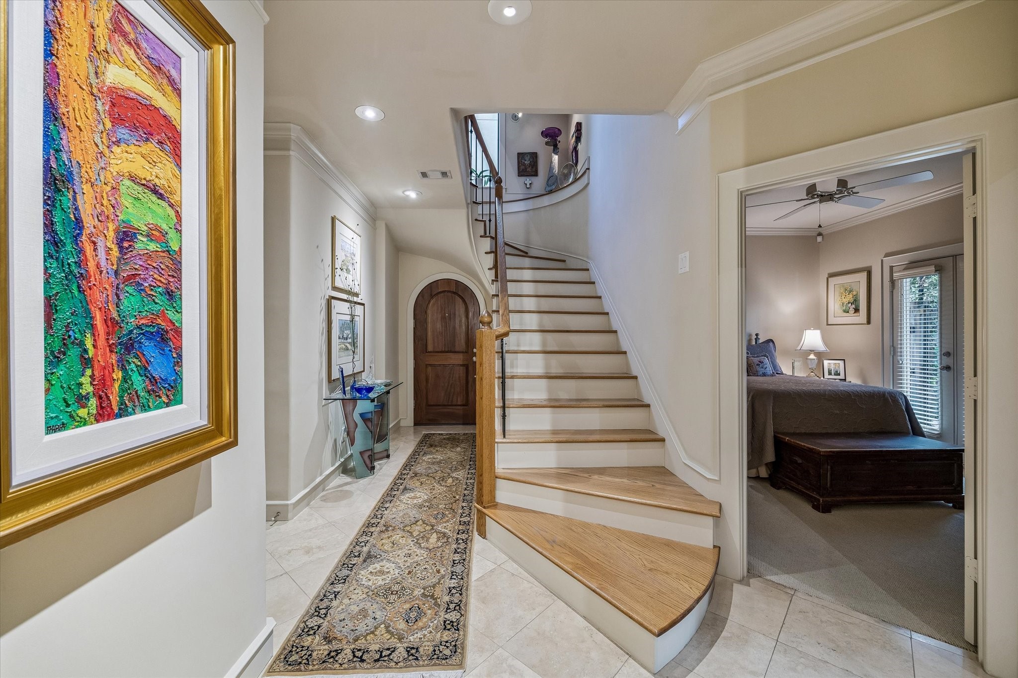 2415 West Main Street Houston, TX 77098 - Photo 13 of 48 Foyer... An elegant entry with crown molding, 6'' baseboards, and soft recessed lighting. A beautifully crafted staircase with rich wood treads and wrought-iron accents adds timeless sophistication.