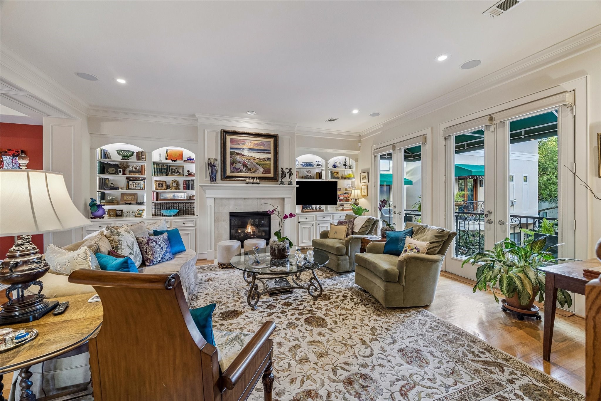 2415 West Main Street Houston, TX 77098 - Photo 21 of 48 Sophisticated details define the space with museum quality lighting for art, a polished travertine gas-log fireplace, custom cabinetry, & privacy shades that elevate comfort & ambiance.