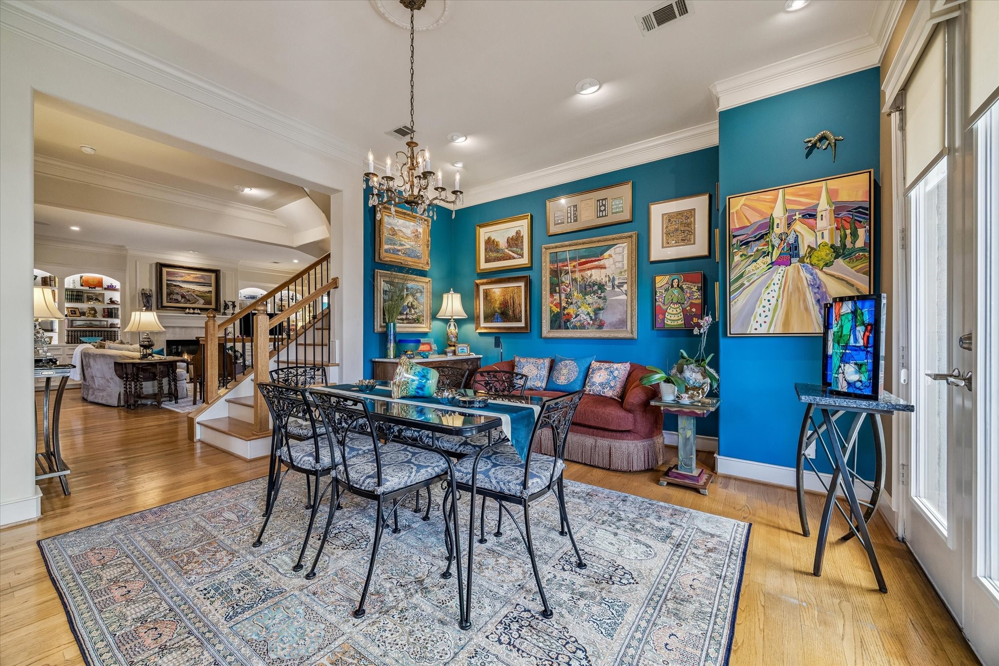 2415 West Main Street Houston, TX 77098 - Photo 25 of 48 The family/breakfast room transitions into the formal living area, enhancing the open concept design, while a nearby integrated staircase leads to the third floor with effortless elegance.