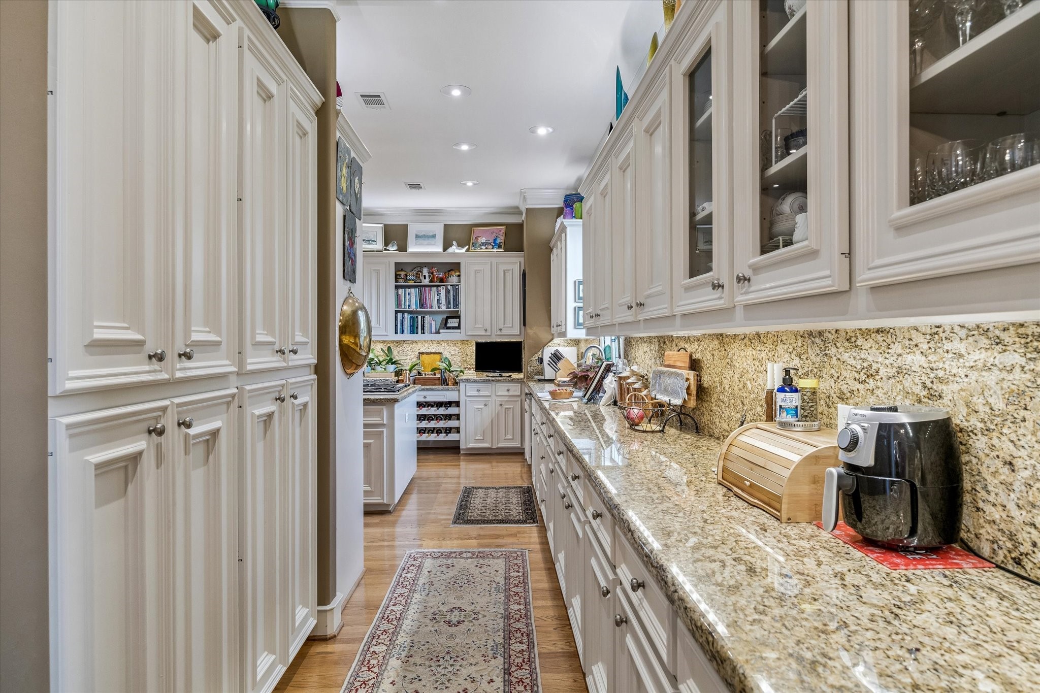 2415 West Main Street Houston, TX 77098 - Photo 28 of 48 The Butler’s Pantry showcases beautifully crafted custom cabinetry and detailed millwork, complemented by expansive counter and cabinet space—perfect for staging, storage, and seamless entertaining.