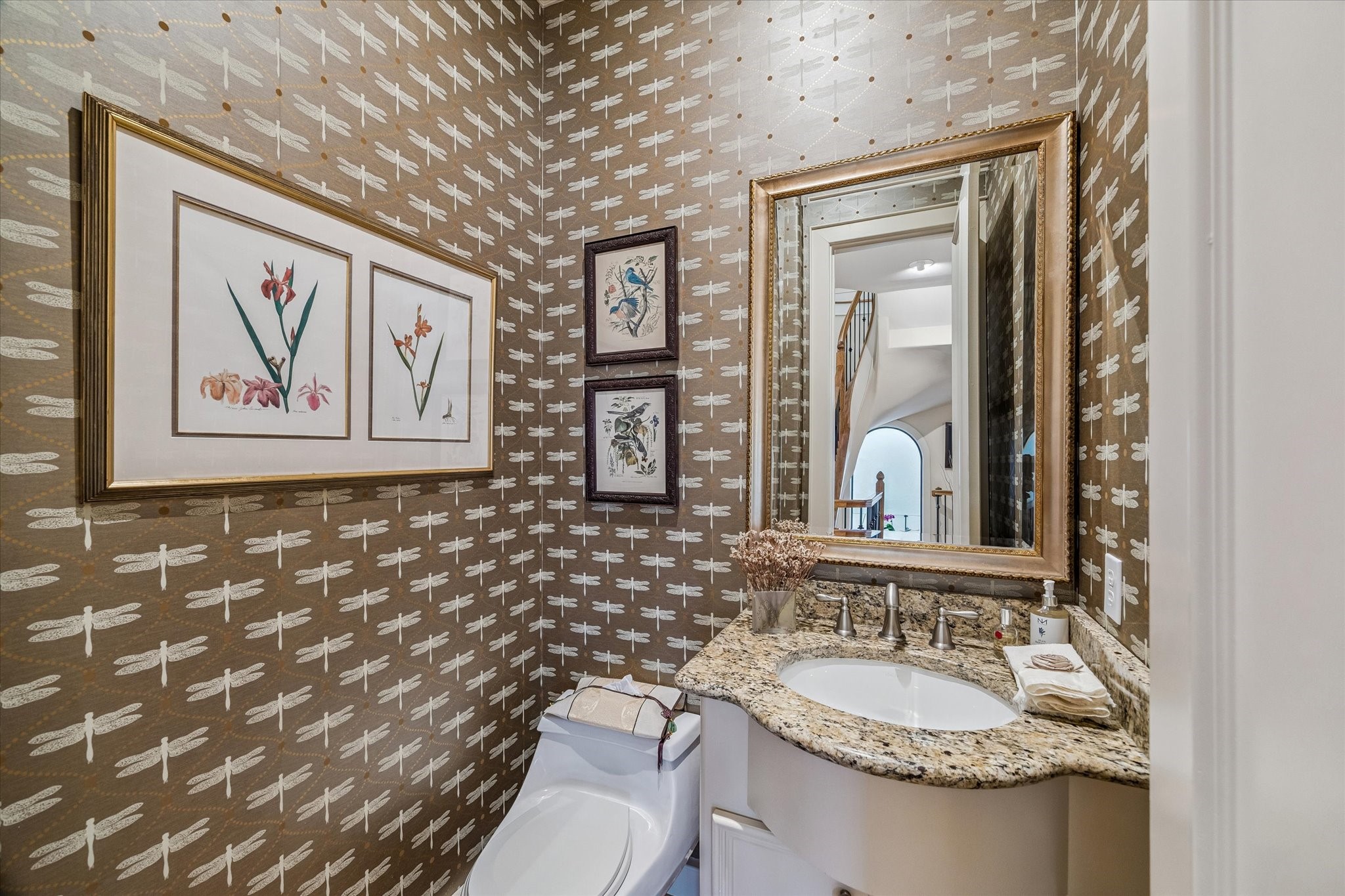 2415 West Main Street Houston, TX 77098 - Photo 29 of 48 Guest Powder Room… Elegant space with hardwood floors, granite counter, Kohler sink, framed mirror, & striking Stroheim & Romann ‘Stefania’ wallpaper for a refined designer touch.