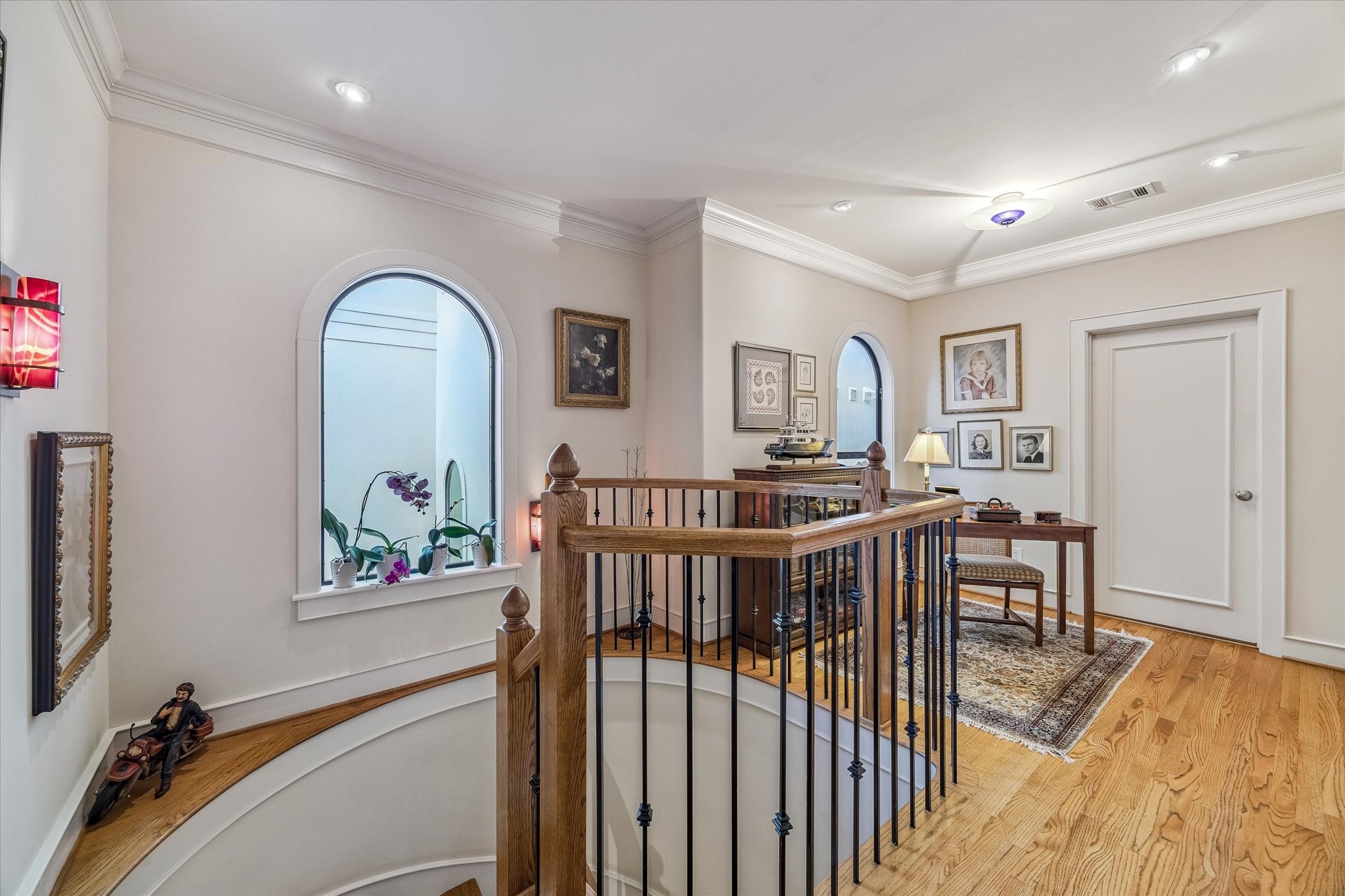 2415 West Main Street Houston, TX 77098 - Photo 31 of 48 Third Floor Landing... The third-floor landing is finished with rich hardwood floors and elegant crown molding, providing a graceful transition space that leads directly to the private primary suite, study and the conveniently located laundry room.