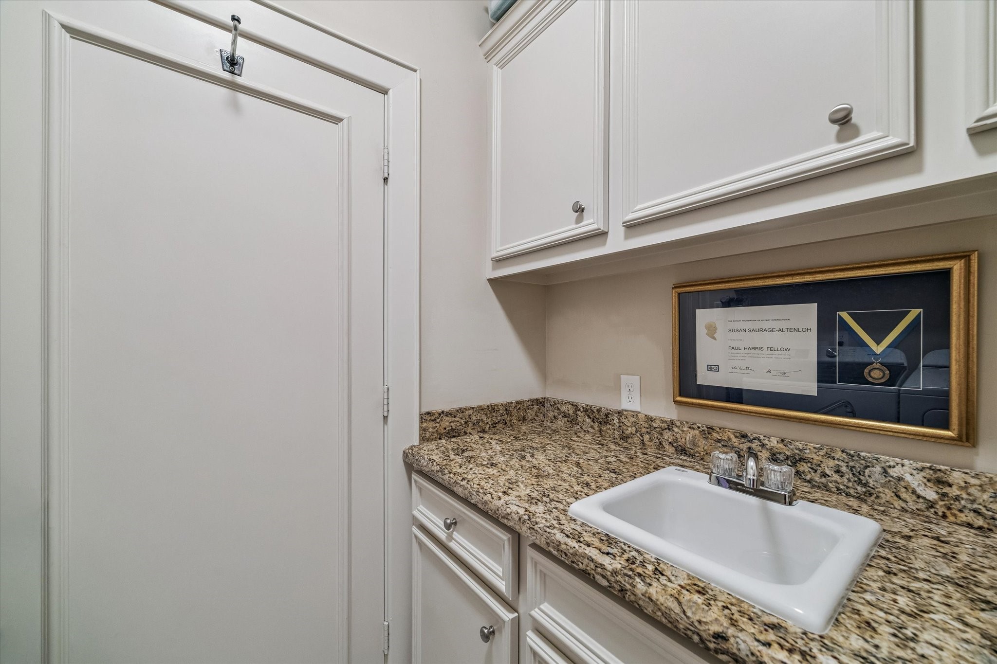 2415 West Main Street Houston, TX 77098 - Photo 38 of 48 Laundry Room… Features granite countertops, utility sink, custom cabinetry, and expansive folding counters—creating an efficient, elegant space for everyday tasks.