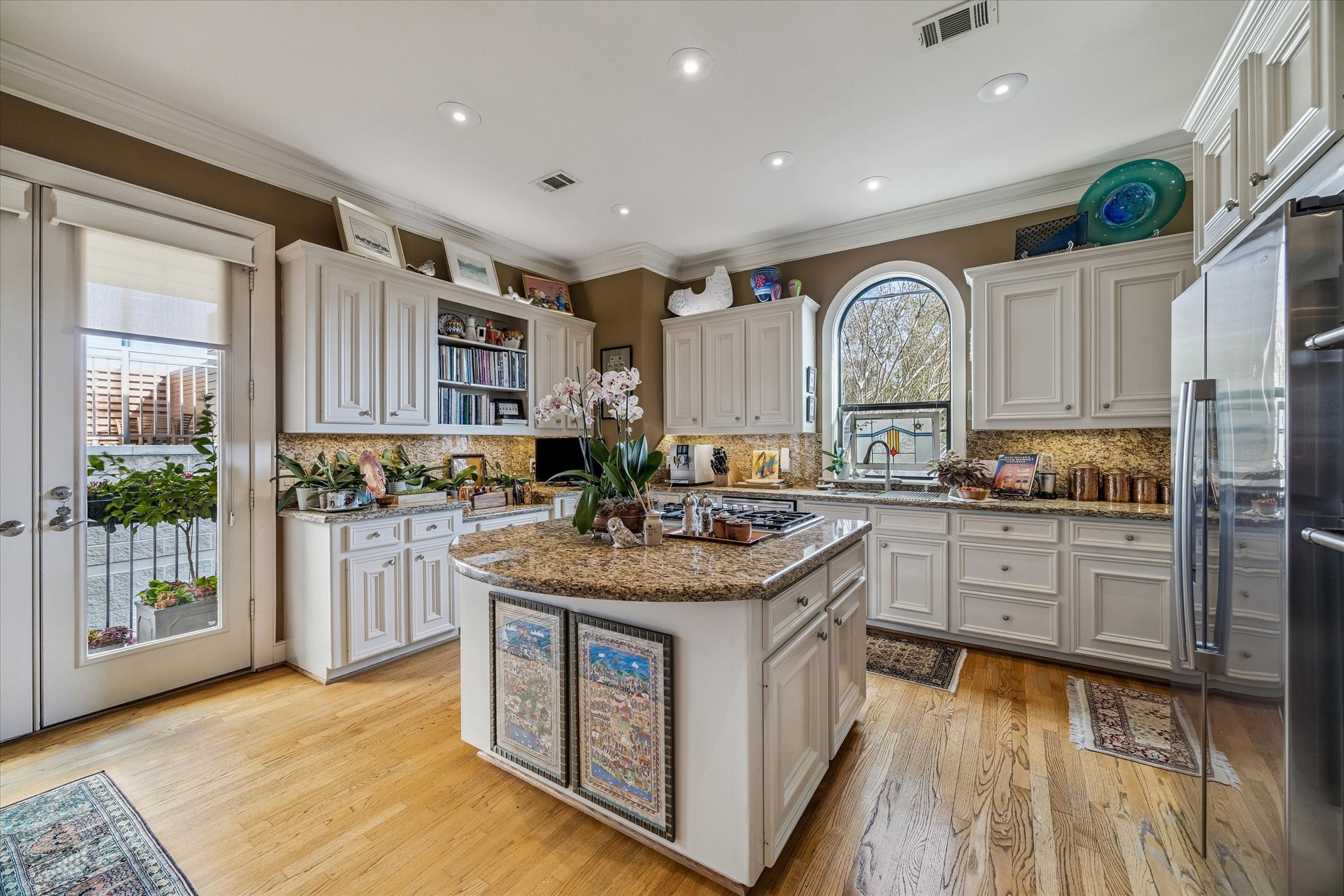 2415 West Main Street Houston, TX 77098 - Photo 4 of 48 Gourmet Island Kitchen... The kitchen showcases granite surfaces paired with premium stainless steel appliances, delivering both beauty and utility.