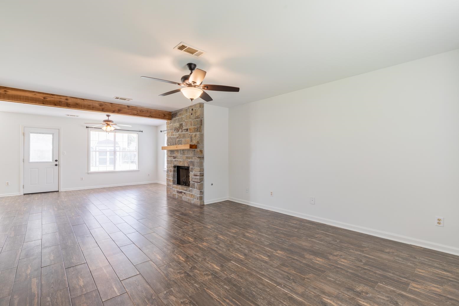 251 Cross Point Cove Collierville, TN 38017 - Photo 12 of 29 a view of an empty room with a window and wooden floor