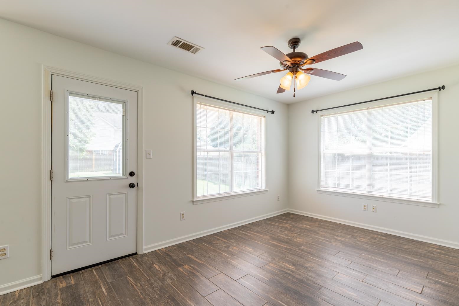 251 Cross Point Cove Collierville, TN 38017 - Photo 13 of 29 a view of an empty room with a window and wooden floor