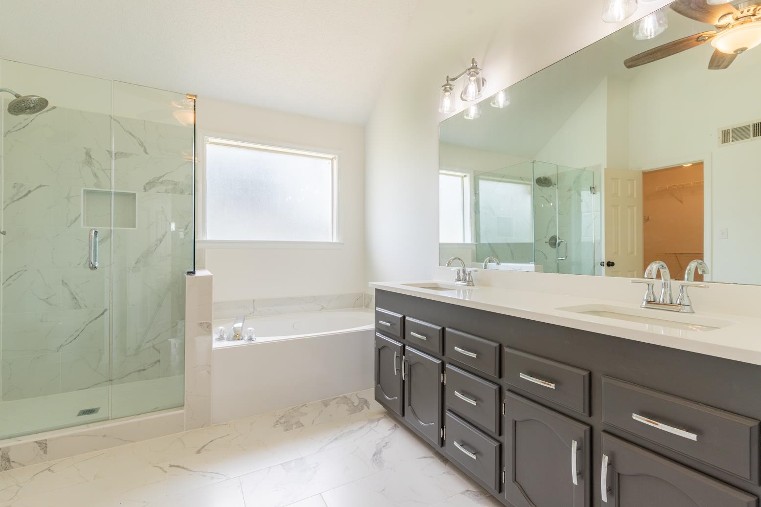 251 Cross Point Cove Collierville, TN 38017 - Photo 16 of 29 a bathroom with a double vanity sink large mirror and shower