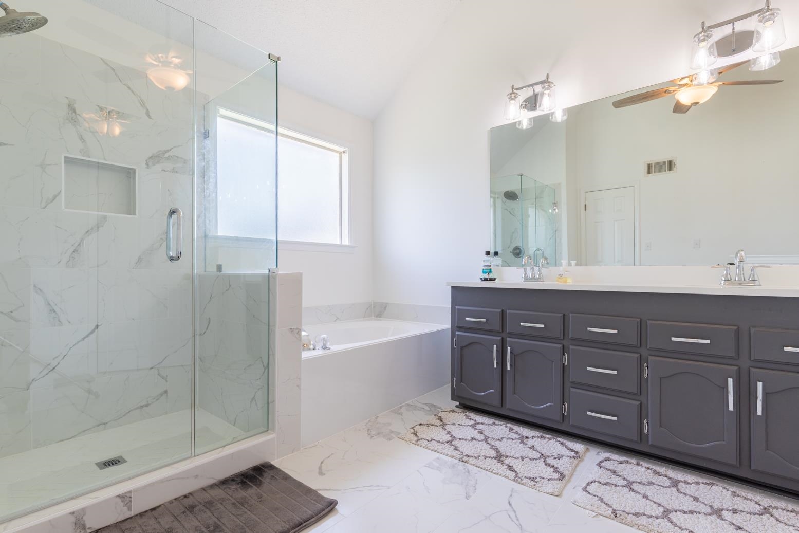 251 Cross Point Cove Collierville, TN 38017 - Photo 19 of 29 a spacious bathroom with a tub sink shower and mirror