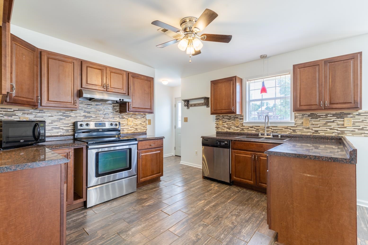 251 Cross Point Cove Collierville, TN 38017 - Photo 6 of 29 a kitchen with granite countertop a stove top oven sink and cabinets