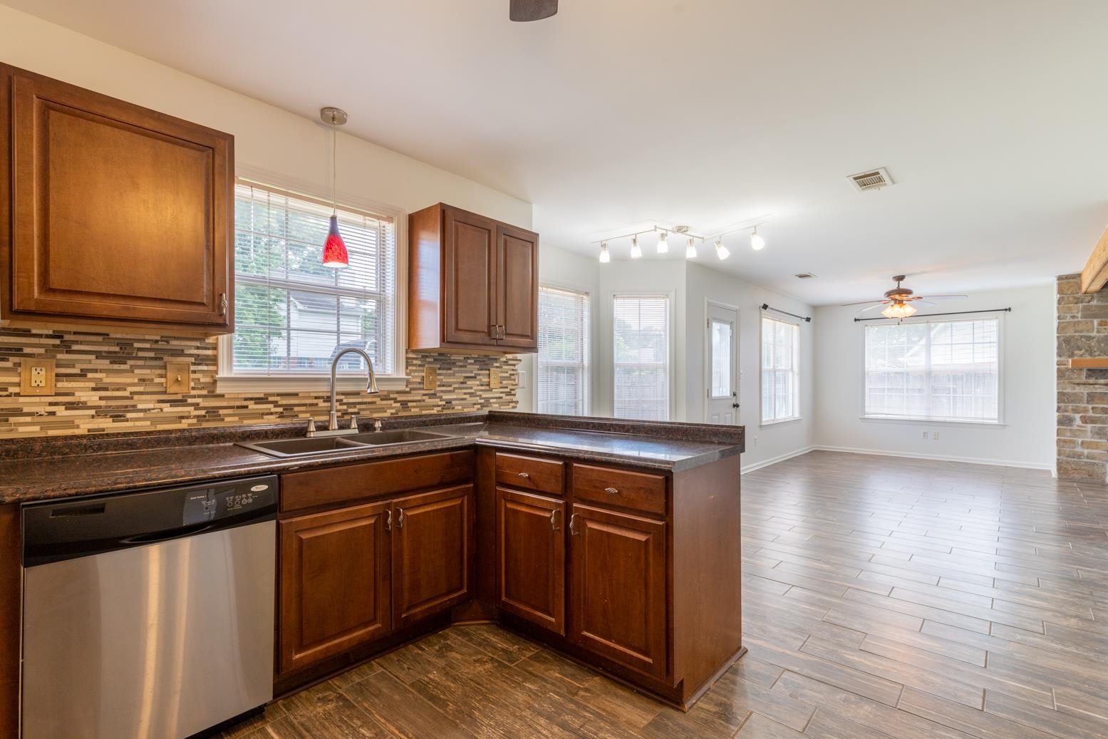 251 Cross Point Cove Collierville, TN 38017 - Photo 7 of 29 a kitchen with stainless steel appliances granite countertop a sink stove and wooden cabinets