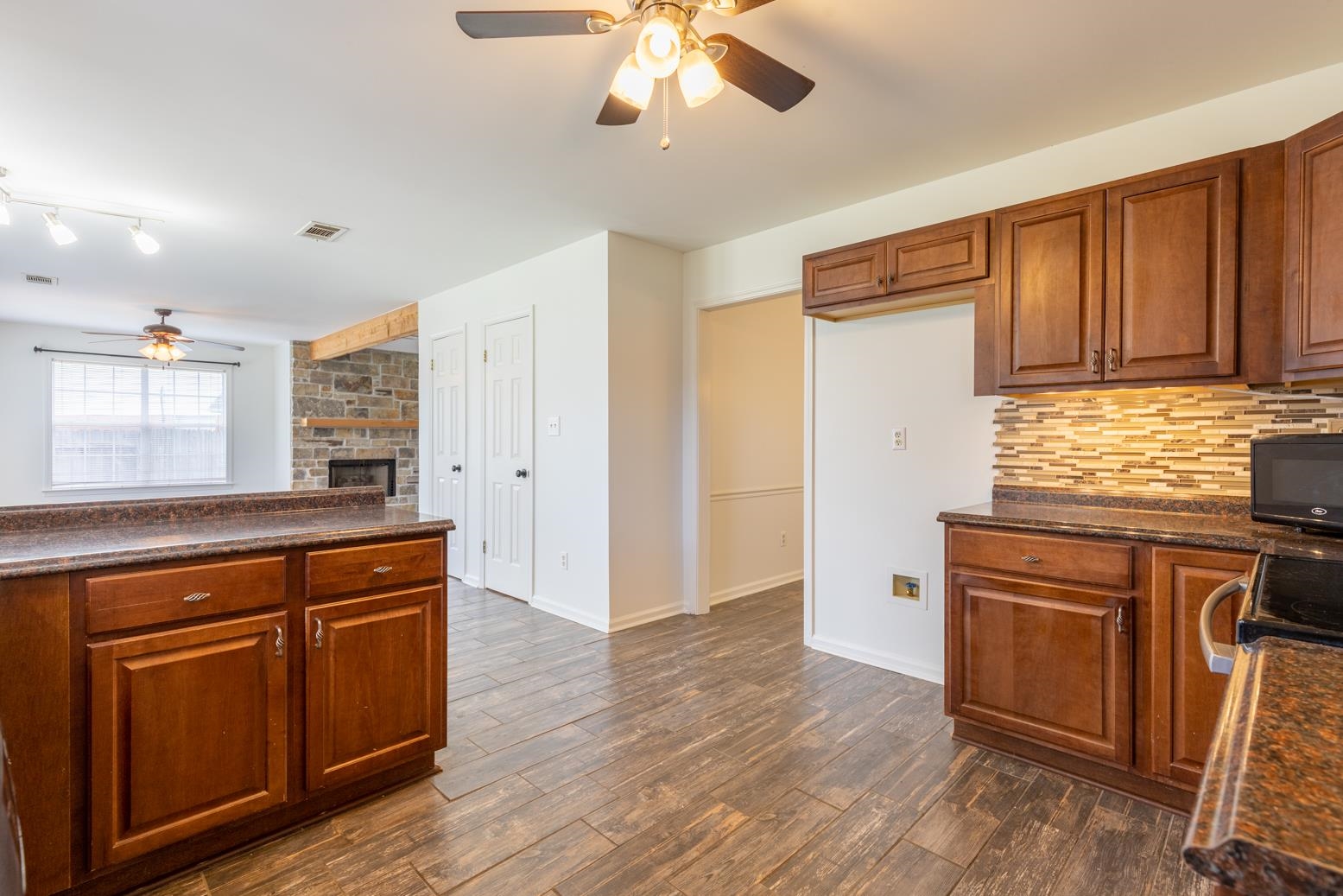 251 Cross Point Cove Collierville, TN 38017 - Photo 8 of 29 a kitchen with wooden floors and white cabinets