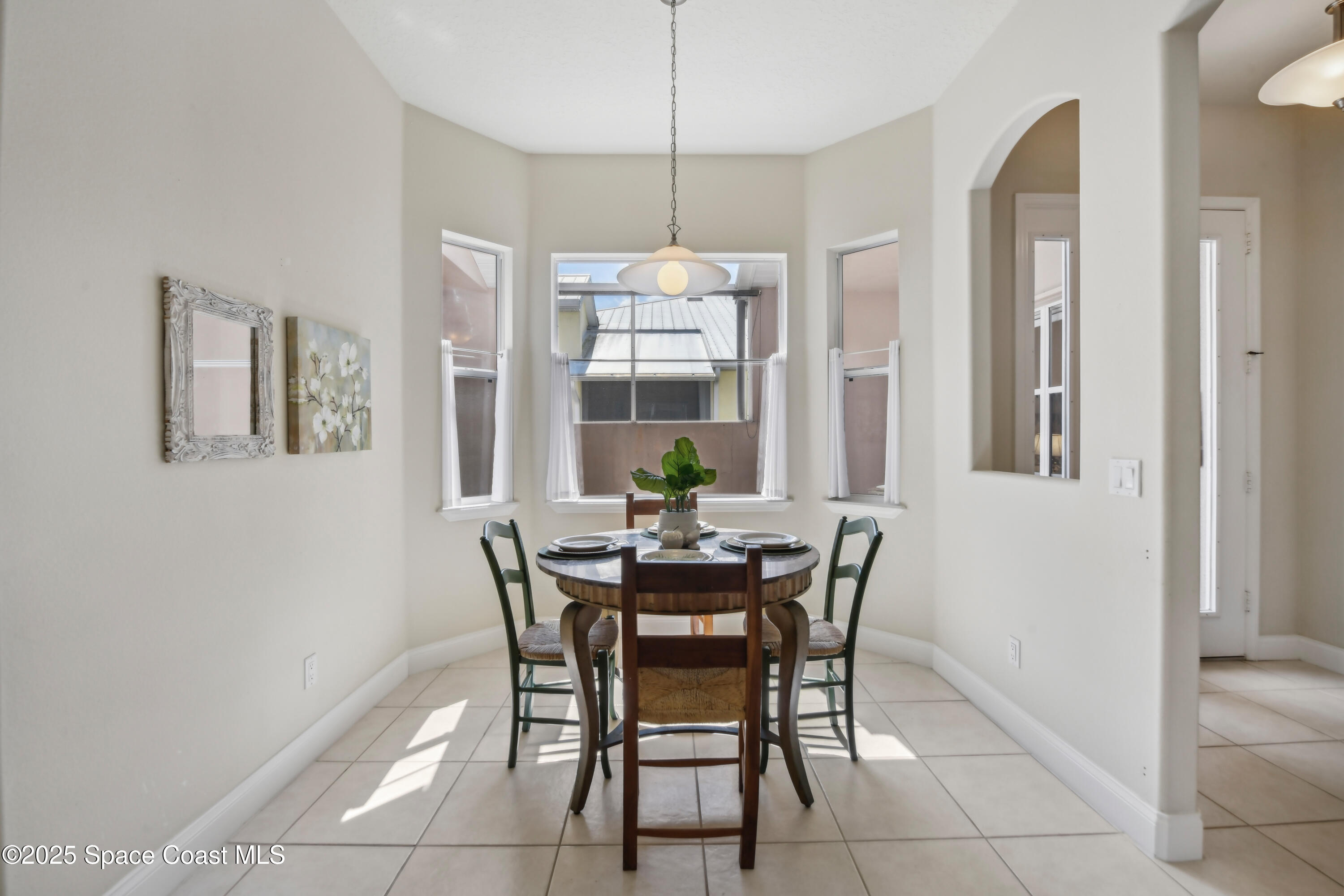 4040 Alamanda Key Drive Melbourne, FL 32901 - Photo 13 of 46 a dining room with furniture and window