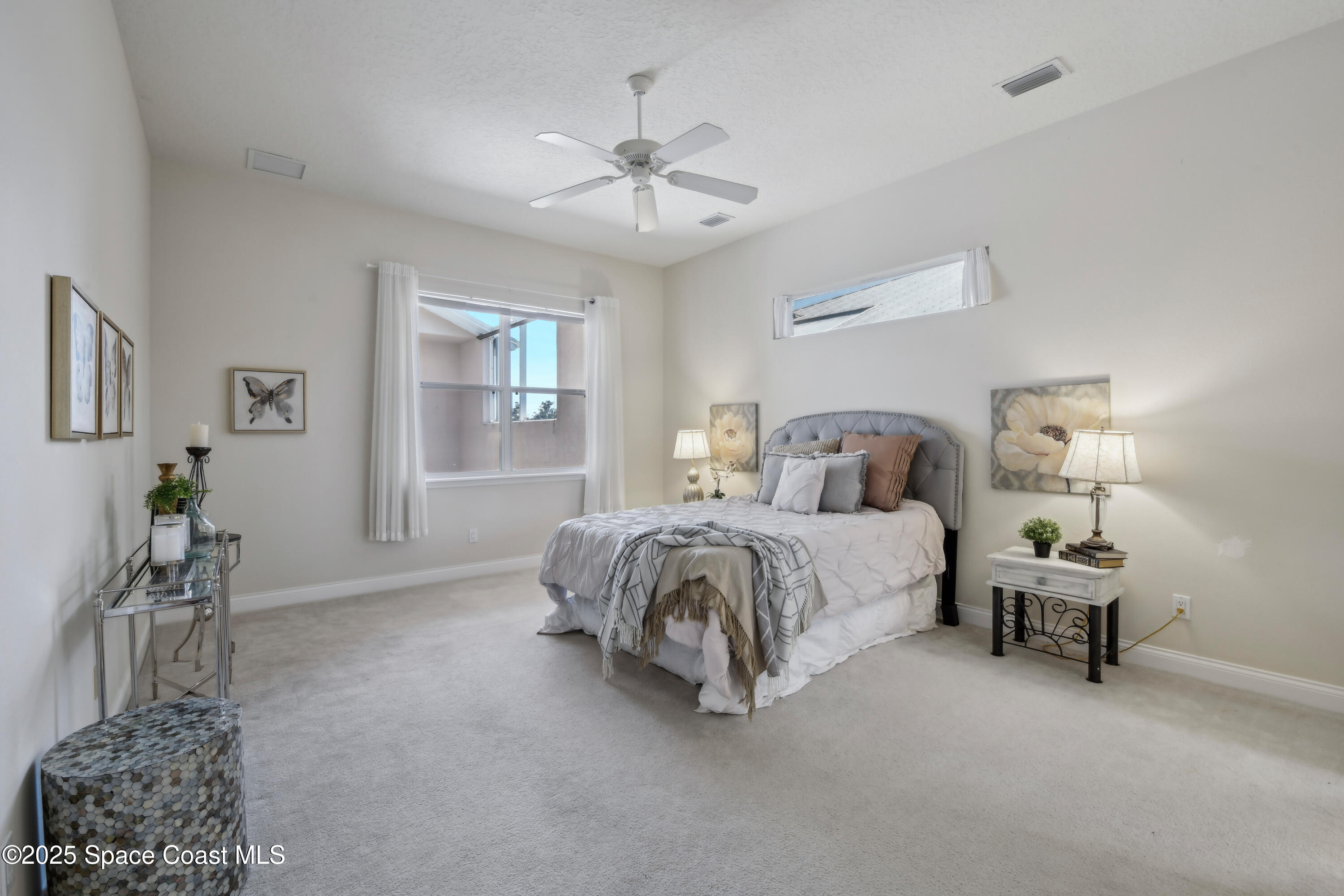 4040 Alamanda Key Drive Melbourne, FL 32901 - Photo 15 of 46 a bedroom with a bed and a chandelier