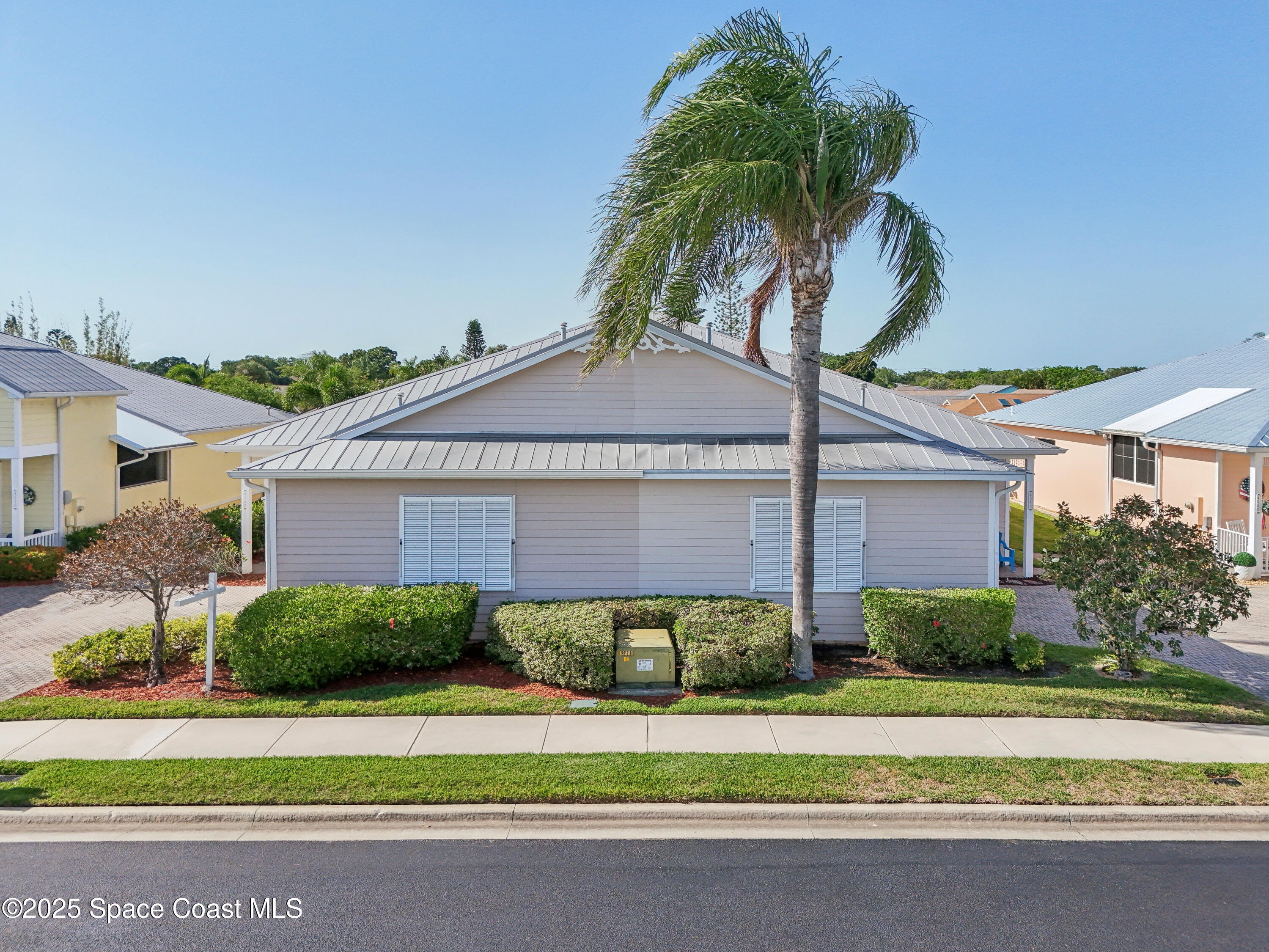 4040 Alamanda Key Drive Melbourne, FL 32901 - Photo 41 of 46 a front view of a house with a garden