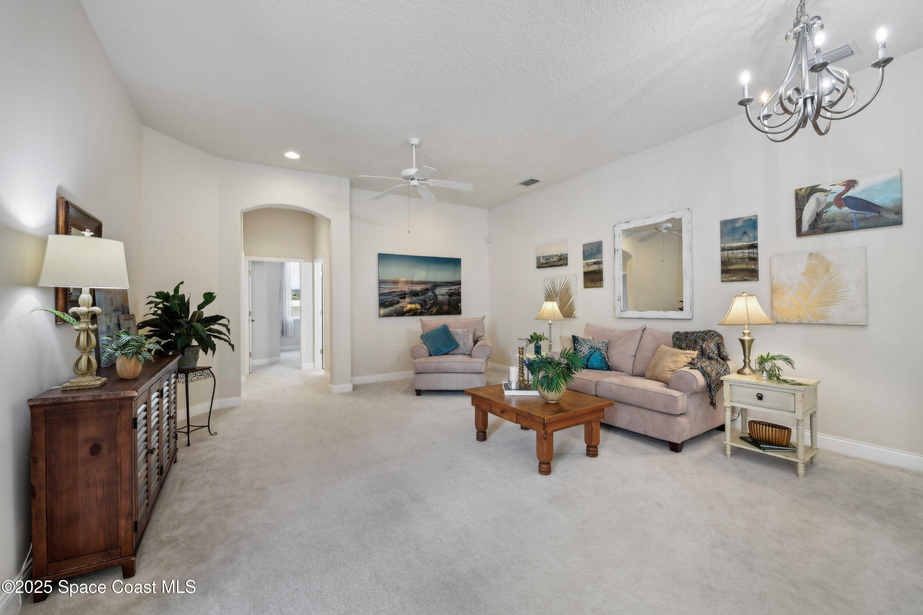 4040 Alamanda Key Drive Melbourne, FL 32901 - Photo 6 of 46 a living room with furniture and a flat screen tv