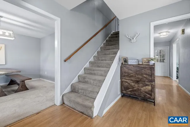 a view of entryway and hall with wooden floor