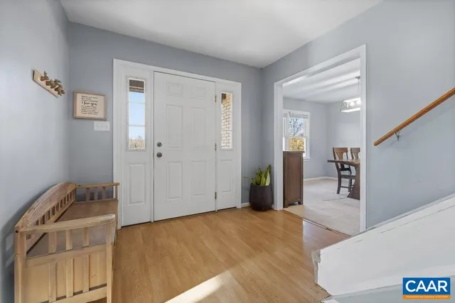 a view of a livingroom with wooden floor and staircase
