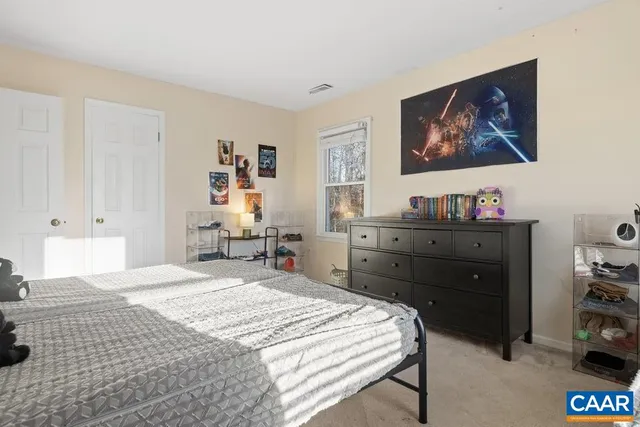 a bedroom with a bed and a desk