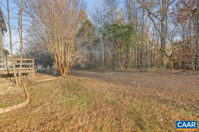 a view of yard covered with snow in front of house