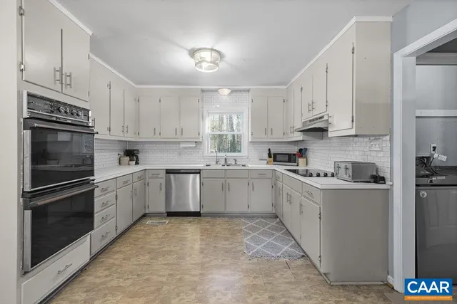 a kitchen with stainless steel appliances granite countertop a refrigerator sink and cabinets