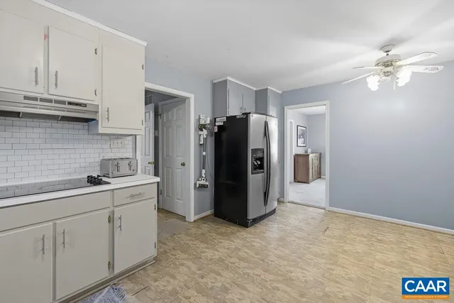 a kitchen with stainless steel appliances a refrigerator sink and cabinets