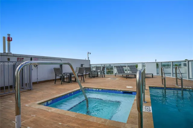 a view of a swimming pool with an outdoor seating