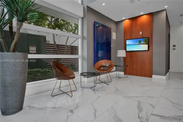 a view of a hall with floor to ceiling window