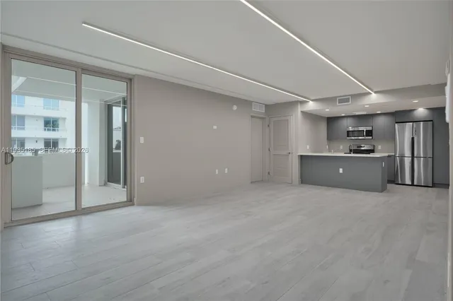 a view of a kitchen with a cabinet and a refrigerator