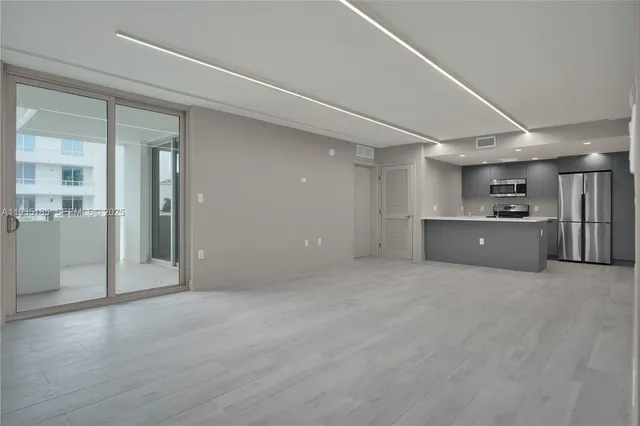 a view of a kitchen with a cabinet and a refrigerator