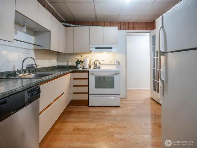 a kitchen with stainless steel appliances granite countertop a refrigerator sink and stove